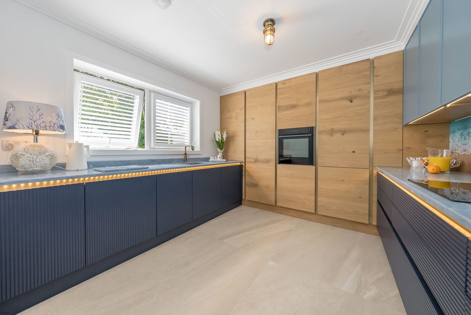 Navy and oak kitchen with built-in oven