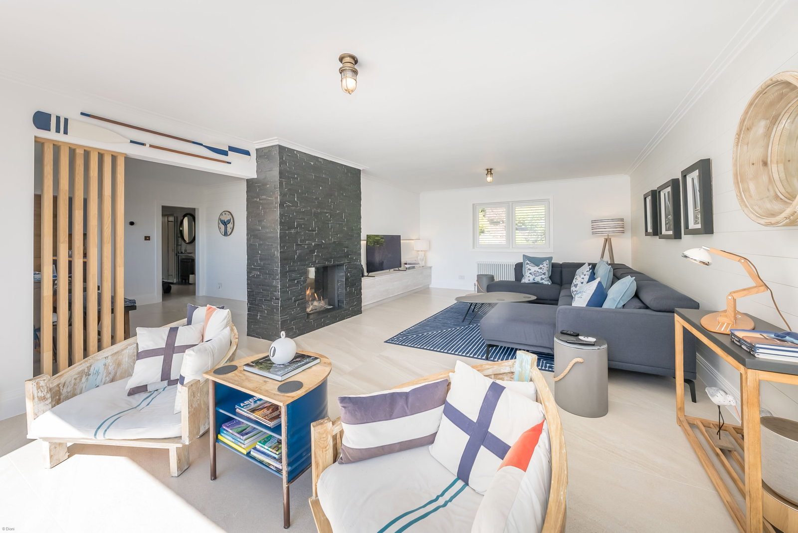Light-filled lounge with fireplace and nautical touches